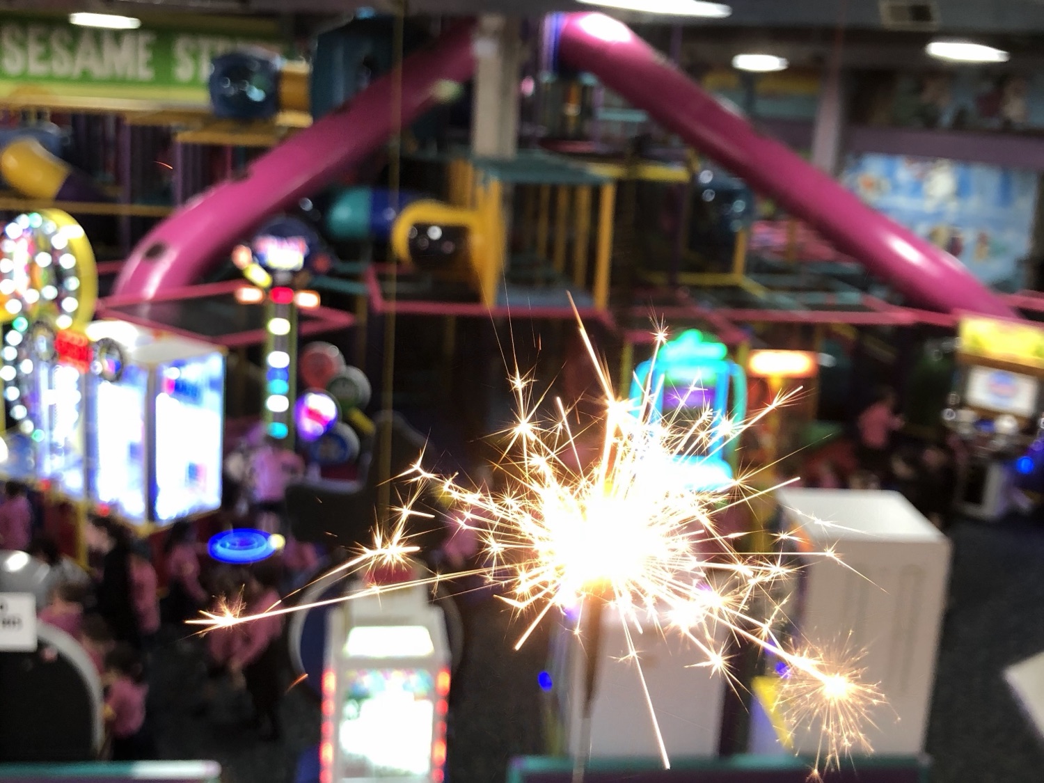 A sparkler lit over the main floor at Kids 'N Action, with the soft play and arcade below